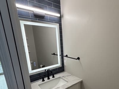 Navy powder room remodeled by Benco Remodeling