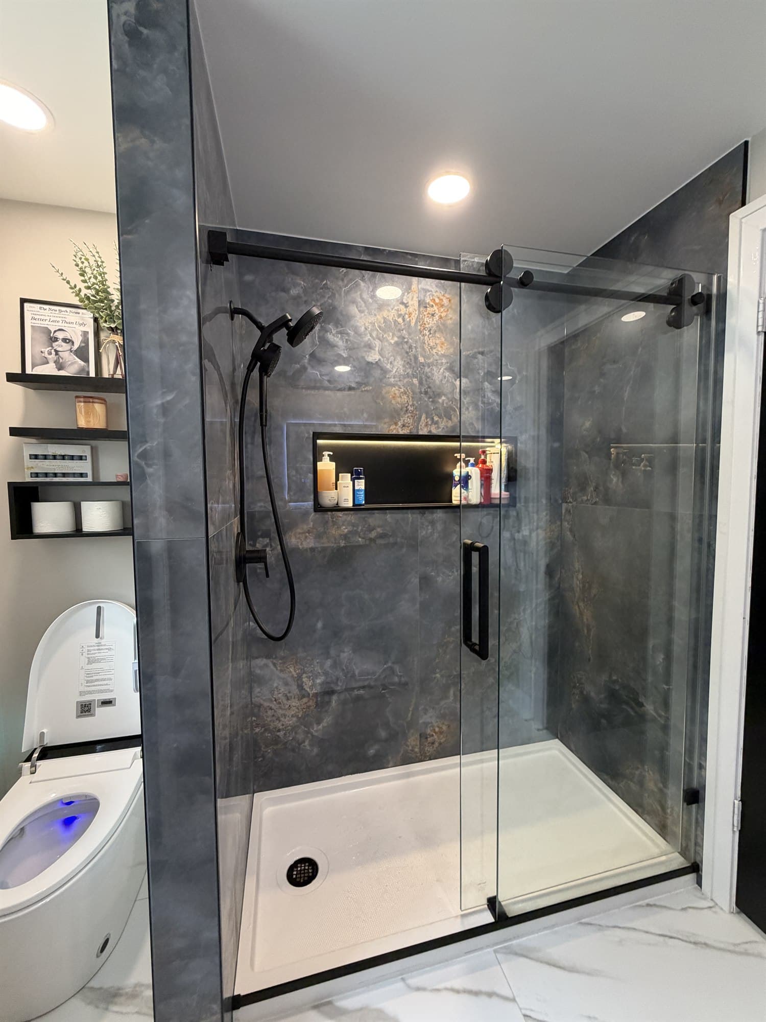 Large-format slate tile shower with a built-in niche, by Benco Remodeling