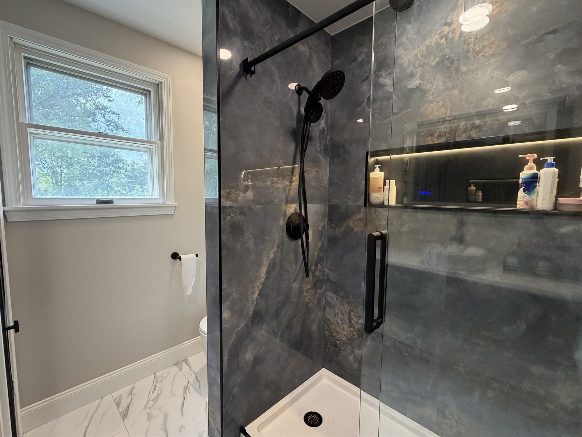 Slate tile shower and surrounding bathroom tiled by Benco Remodeling